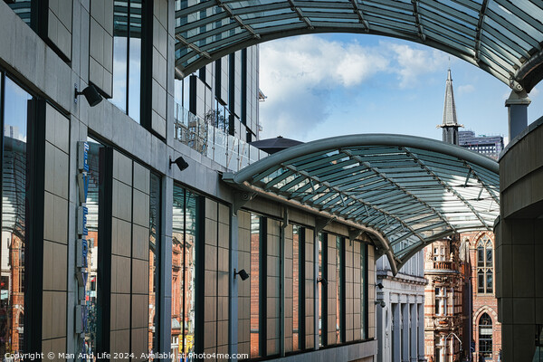 Modern glass-covered walkway with urban architecture and blue sky in the background in Leeds, UK. Picture Board by Man And Life
