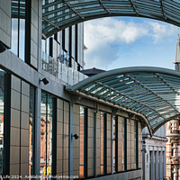 Buy canvas prints of Modern glass-covered walkway with urban architecture and blue sky in the background in Leeds, UK. by Man And Life