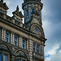 Buy canvas prints of Vintage clock tower on an old European-style building against a cloudy sky in Leeds, UK. by Man And Life