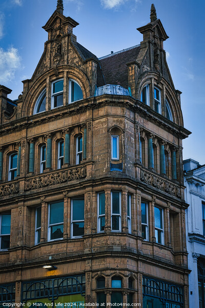 Victorian architecture with ornate details on a historic building's facade against a blue sky in Leeds, UK. Picture Board by Man And Life