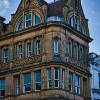Buy canvas prints of Victorian architecture with ornate details on a historic building's facade against a blue sky in Leeds, UK. by Man And Life