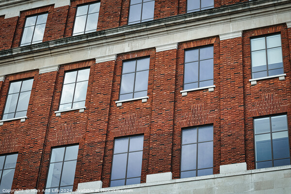 Facade of a brick building with symmetrical windows reflecting the sky, architectural background in Leeds, UK. Picture Board by Man And Life