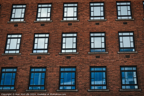 Facade of a brick building with symmetrical windows reflecting the sky in Leeds, UK. Picture Board by Man And Life