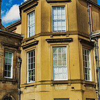 Buy canvas prints of Classic European architecture with a clear blue sky. The building features a warm beige facade, large windows, and traditional stonework details in York, North Yorkshire, England. by Man And Life