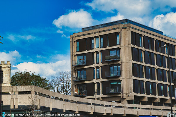 Modern urban apartment building with balconies against a blue sky with fluffy clouds. Architectural exterior of residential structure in a city setting in York, North Yorkshire, England. Picture Board by Man And Life