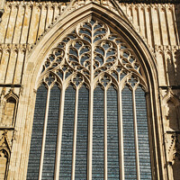 Buy canvas prints of Gothic architecture detail of a cathedral window with intricate tracery and stained glass, set against a clear blue sky in York, North Yorkshire, England. by Man And Life