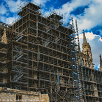 Buy canvas prints of Gothic cathedral undergoing restoration, with extensive scaffolding against a dramatic cloudy sky in York, North Yorkshire, England. by Man And Life