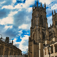Buy canvas prints of Dramatic sky over a majestic Gothic cathedral with intricate architecture, flanked by historic buildings, showcasing a blend of heritage and natural beauty in York, North Yorkshire, England. by Man And Life