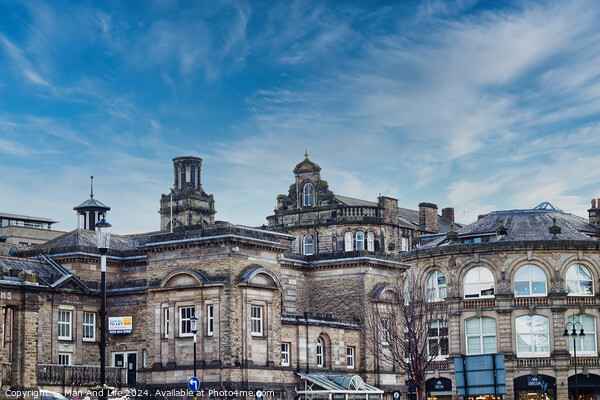 Classic European architecture under a dynamic sky with wispy clouds, showcasing historic buildings with intricate facades in an urban setting in Harrogate, North Yorkshire. Picture Board by Man And Life