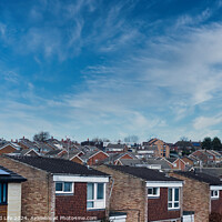 Buy canvas prints of Suburban skyline with rows of houses and solar panels on a roof under a blue sky with wispy clouds in Harrogate, North Yorkshire. by Man And Life