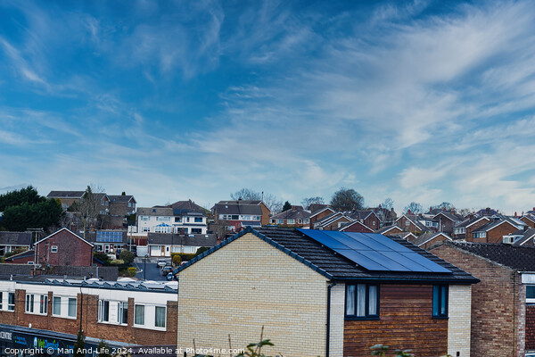 Suburban landscape with residential houses featuring solar panels under a dynamic blue sky with wispy clouds, showcasing sustainable living in a modern neighborhood in Harrogate, North Yorkshire. Picture Board by Man And Life