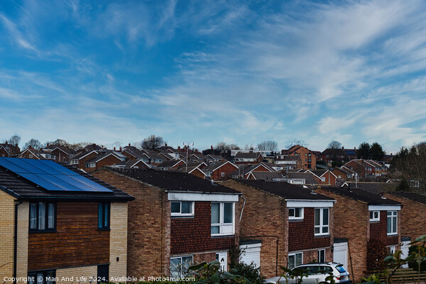 Suburban landscape with rows of British houses, featuring solar panels on roofs under a dynamic blue sky with wispy clouds in Harrogate, North Yorkshire. Picture Board by Man And Life