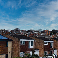 Buy canvas prints of Suburban landscape with rows of British houses, featuring solar panels on roofs under a dynamic blue sky with wispy clouds in Harrogate, North Yorkshire. by Man And Life