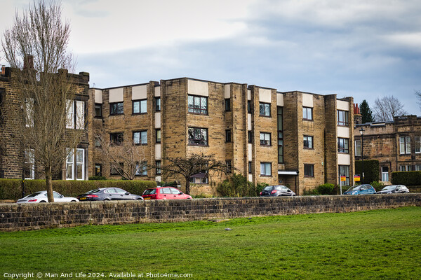 Modern residential apartment buildings with parked cars in front, behind a stone wall with a lush green lawn in the foreground. Urban living concept in Harrogate, North Yorkshire. Picture Board by Man And Life