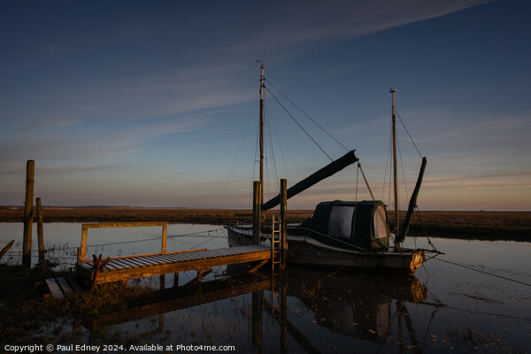 Boat at jetty in calm morning light Picture Board by Paul Edney