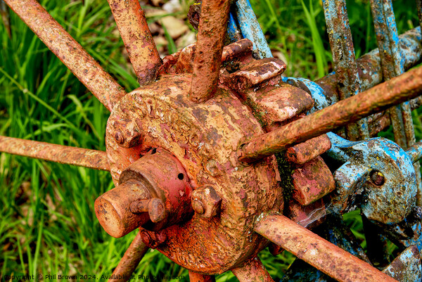 Very rusty horse drawn, hay rake wheel hub. Picture Board by Phil Brown