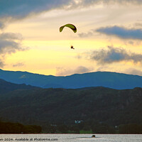 Buy canvas prints of Paraglider flies above Windermere at dusk. by Phil Brown