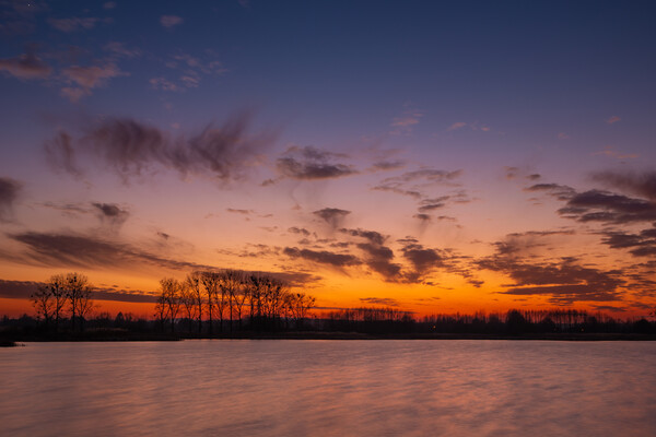 Colorful evening sky after sunset over the lake Picture Board by Dariusz Banaszuk