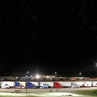Buy canvas prints of Night Rest, clear night sky, with stars, over transporters lined up, parked by Pete Klinger