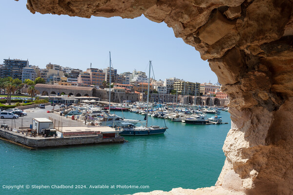 picturesque port viewed from an arch in the old fort at Heraklion Picture Board by Stephen Chadbond