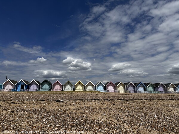 Beach huts in Mersea Picture Board by JAMES UMNEY