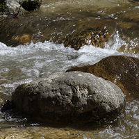 Buy canvas prints of whirling water over boulders near Rasinari by Adrian Bud