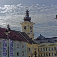 Buy canvas prints of City Hall near Chatolic Cathedral Sibiu Romania by Adrian Bud