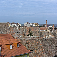 Buy canvas prints of Old roofs and the new one in Old Town Sibiu Romani by Adrian Bud