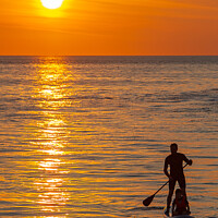 Buy canvas prints of Paddle Board And Passenger At Sunset by James Lavott