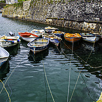 Buy canvas prints of Rowing boats In Mevagissey Outer Harbour by James Lavott