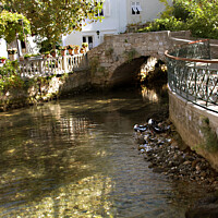 Buy canvas prints of The stream going through Mlini, Croatia on its way to the sea by Jacqi Elmslie