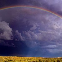 Buy canvas prints of Rainbow over the Desert Storm by Heath Birrer