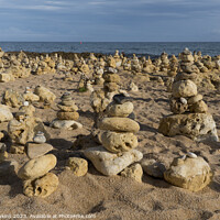 Buy canvas prints of Oura beach stone stacks by Rob Hawkins