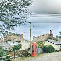 Buy canvas prints of Phone box and cottages by Alexia Miles