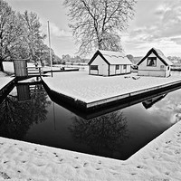 Buy canvas prints of Coltishall Boat Houses in Winter B&W by Paul Macro