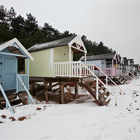 Buy canvas prints of Pastel Beach Huts amid the Snow by Paul Macro