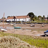 Buy canvas prints of Burnham Boathouse from the Marshes by Paul Macro