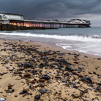 Buy canvas prints of Stormy Sunset over Cromer Pier by Paul Macro