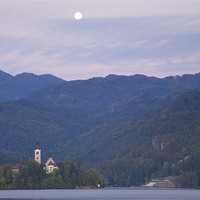 Buy canvas prints of Moon setting at sunrise Lake Bled by Ian Middleton