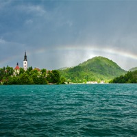Buy canvas prints of Rainbow over Lake Bled by Ian Middleton