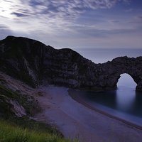 Buy canvas prints of Durdle Door under a moonlit sky by Ian Middleton