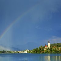 Buy canvas prints of Rainbow over Lake Bled by Ian Middleton