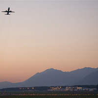 Buy canvas prints of Aircraft taking off at dusk by Ian Middleton