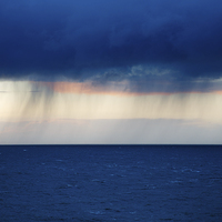 Buy canvas prints of Rain on the horizon at Strumble Head by Ian Middleton
