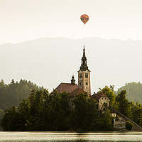 Buy canvas prints of Hot air Balloon over Lake Bled and the Island chur by Ian Middleton