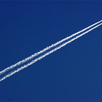 Buy canvas prints of Airplane trail in blue sky by patrick dinneen