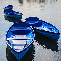 Buy canvas prints of Blue boats on a lake by Oxon Images