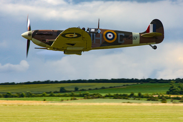 Low flying Spitfire over Duxford Picture Board by Oxon Images