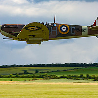Buy canvas prints of Low flying Spitfire over Duxford by Oxon Images