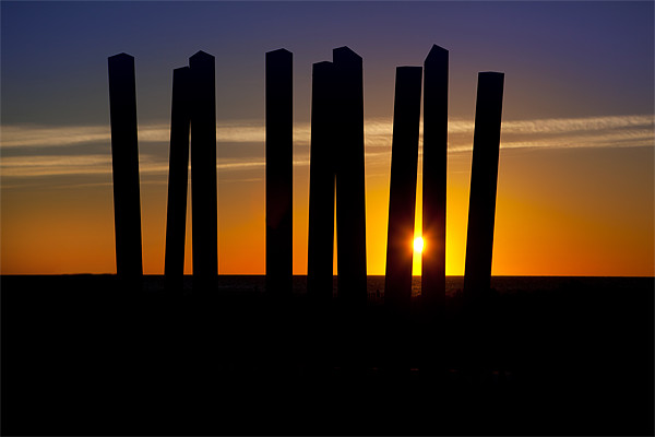 Sunrise through a sculpture. Picture Board by David Hare